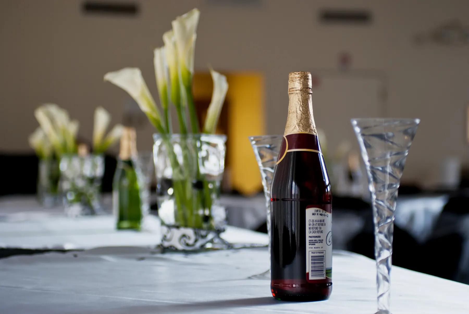 Champagne and calla lilies on a reception table