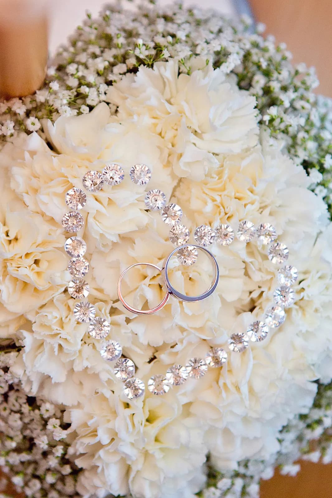 Two wedding rings resting on white blooms